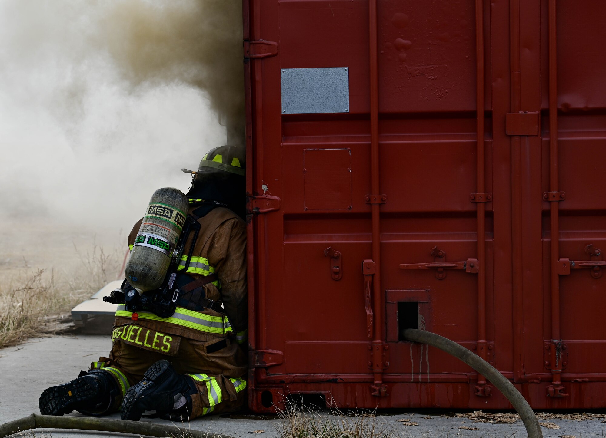 U.S. Air Force Staff Sgt. Bobby Arguelles, 8th Civil Engineer Squadron firefighter, peeks through a burn house entrance during a joint training event at Kunsan Air Base, Republic of
Korea, Mar. 9, 2023. To maintain their technical expertise, firefighters train year-round on various techniques such as fire suppression, aviation fire suppression, hazardous materials and emergency medical services. (U.S. Air Force photo by Senior Airman Shannon Braaten)
