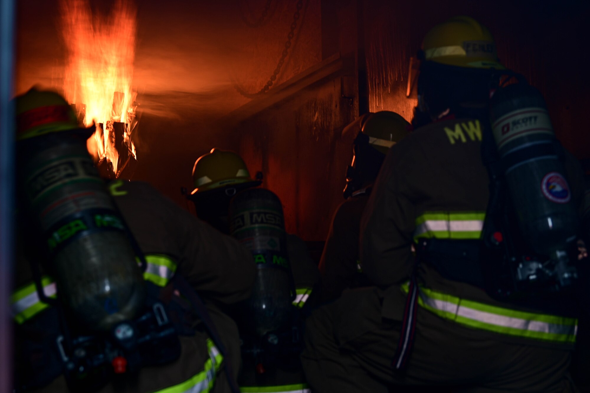 Firefighters from the U.S. Air Force 8th Civil Engineer Squadron and U.S. Marine Corps Marine Wing Support Squadron 172, Camp Foster, Okinawa, Japan, prepare to put out a controlled fire during a joint training event at Kunsan Air Base, Republic of Korea, Mar. 9, 2023. During the training, both teams shared techniques with the intent of sharpening their capabilities as first responders. (U.S. Air Force photo by Senior Airman Shannon Braaten)