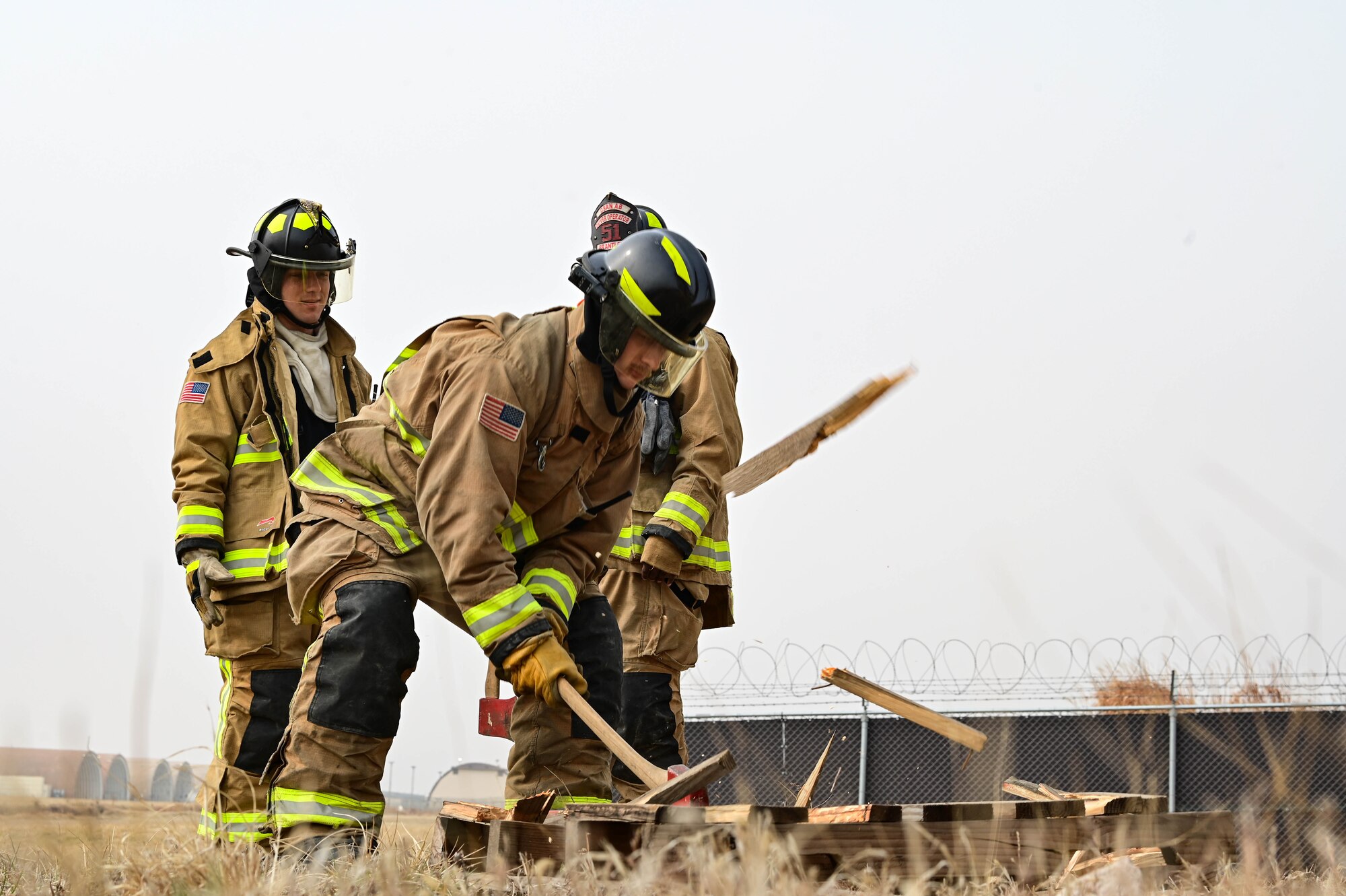 U.S. Air Force Airman 1st Class Jadon Davis, 8th Civil Engineer Squadron firefighter, chops wood for a controlled burn during a joint training event at Kunsan Air Base, Republic of Korea, Mar. 9, 2023. The event exposed the participants to diverse scenarios, with the goal of being prepared for any situation. (U.S. Air Force photo by Senior Airman Shannon Braaten)