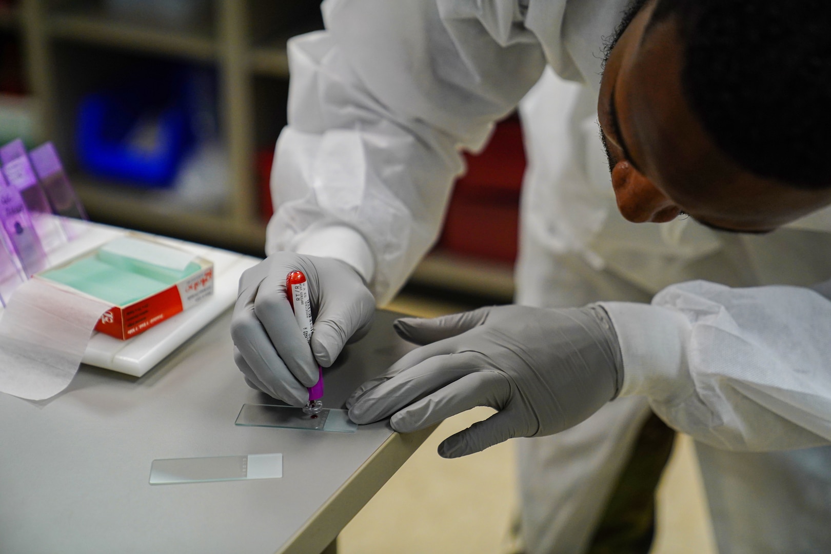 U.S. Air Force Senior Airman Ashton Johnson, 81st Medical  Diagnostic and Therapeutics Squadron medical laboratory technician, creates blood slides at the Keesler Medical Center on Keesler Air Force Base, Mississippi, Feb. 28, 2023.