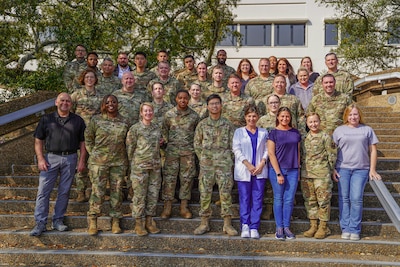 The members from the 81st Medical Diagnostic and Therapeutics Squadron pose for photo outside of the Keesler Medical Center at Keesler Air Force Base, Mississippi, Feb. 28, 2023.