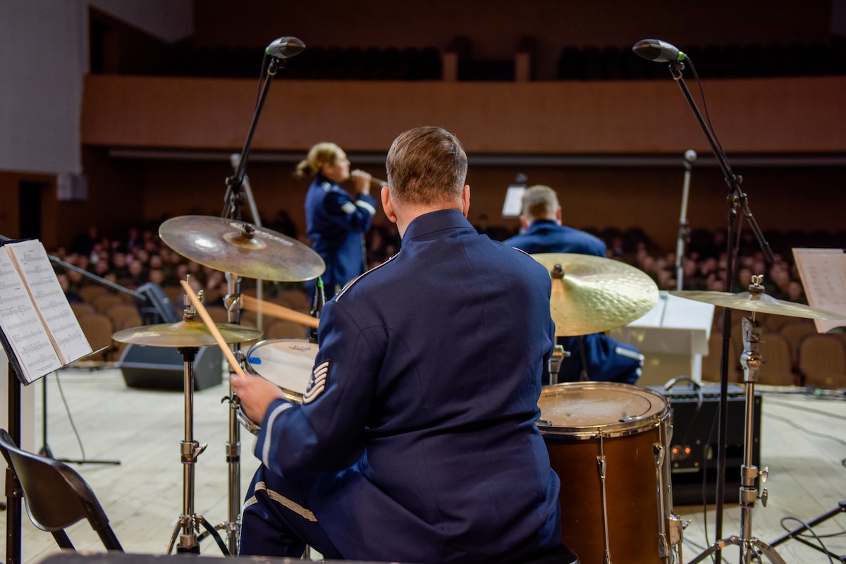 A man plays a drumset