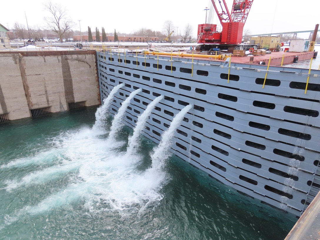 The U.S. Army Corps of Engineers, Detroit District, Soo Project Office begins the dewatering process by opening holes in the stop logs located on the upstream end of the Poe Lock in Sault Ste. Marie, Michigan on March 10, 2023.
