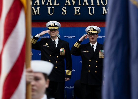 230315-N-LY160-1095 PENSACOLA, Fla. (March 15, 2023) – Capt. Alan B. Christian, commanding officer of Navy Medicine Readiness and Training Command Pensacola and director of Naval Hospital Pensacola, left, and Capt. Scott D. Coon, salute during the national anthem for a change of command ceremony at the National Naval Aviation Museum in Naval Air Station Pensacola, March 15. (U.S. Navy photo by Mass Communication Specialist 1st Class Michael H. Lee)
