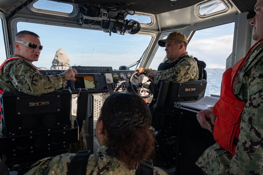 Capt. Odin J. Klug, commanding officer, Naval Support Activity (NSA) Souda Bay, discusses proper boat maneuvering procedures with Sailors assigned to NSA Souda Bay’s Harbor Patrol Unit (HPU) during a HPU Inspection on March 7, 2023.