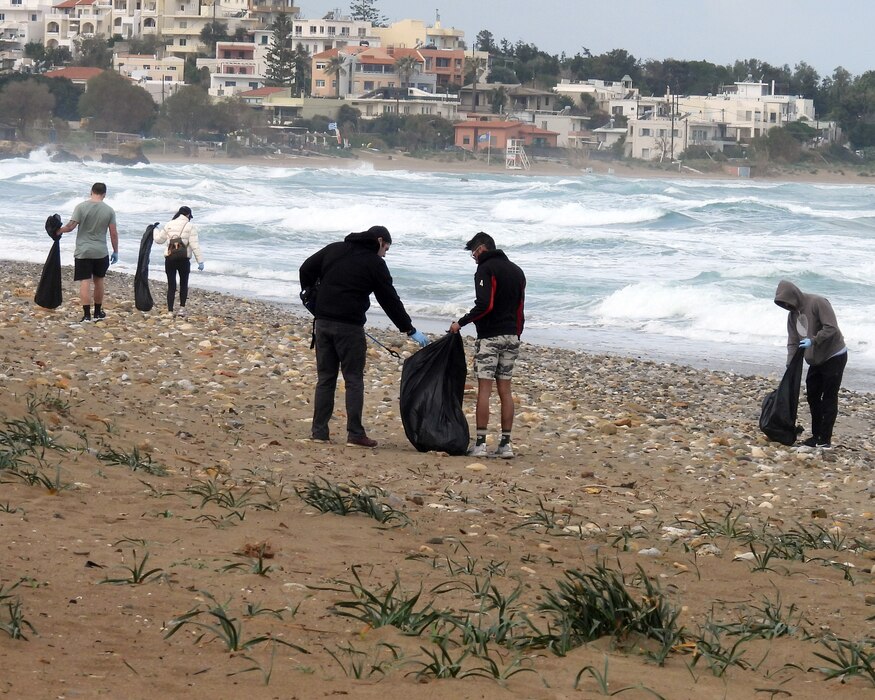 NAVAL SUPPORT ACTIVITY SOUDA BAY, Greece (March 13, 2023) Sailors assigned to the Nimitz-class aircraft carrier USS George H.W. Bush (CVN 77) participate in a community outreach event in Chania, Crete, March 13, 2023. The volunteers collected trash from Kladisos Beach and a nearby park to help preserve the scenic environment and are seen on the beach putting trash into garbage bags with the ocean behind them.