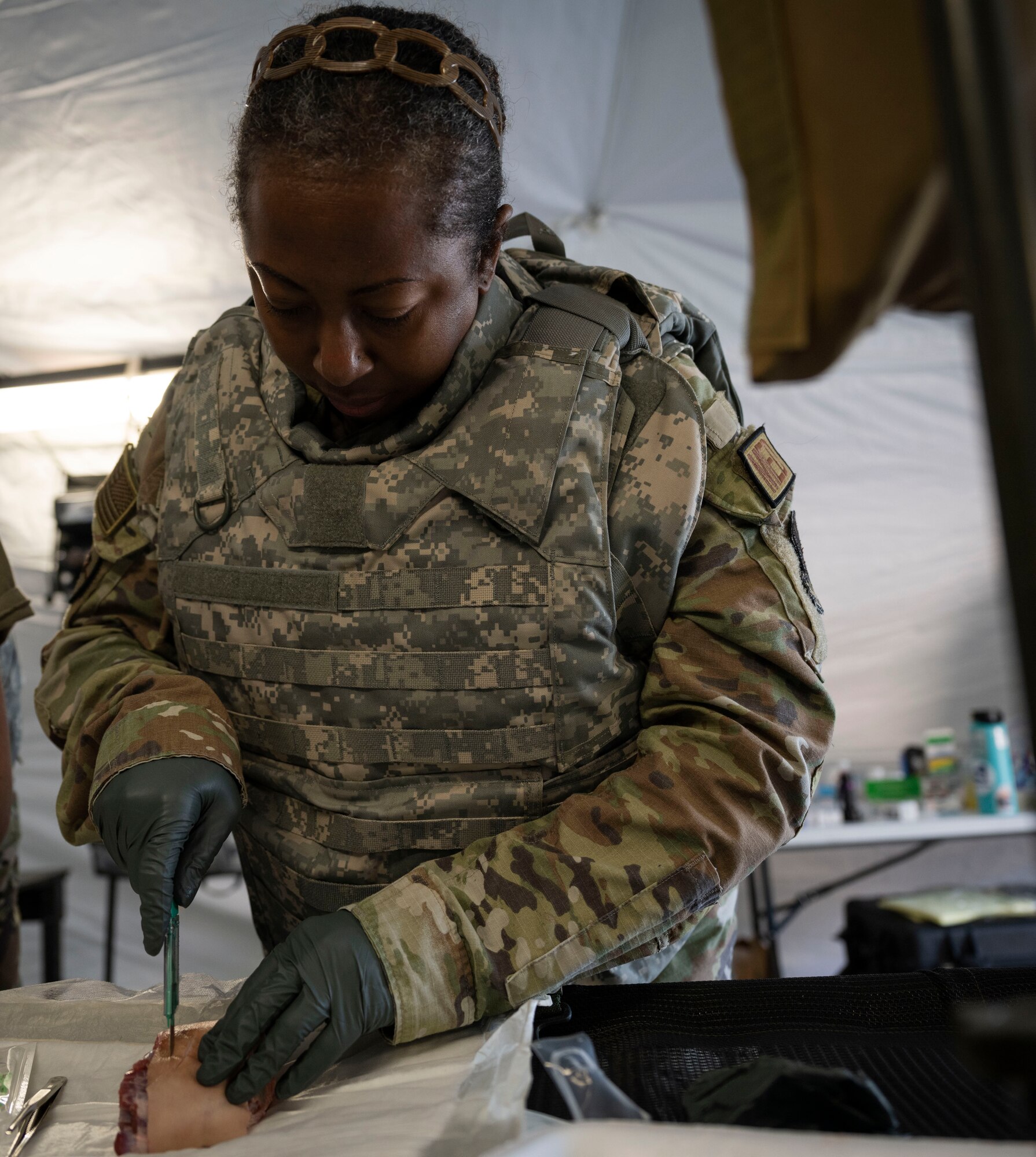 Maj. Early Rice, 4th Medical Group nurse, practices administering sutures during Agile Cub 4 at Marine Corps Air Station Cherry Point, North Carolina, March 7, 2023. This agile combat employment exercise shifts the generation of airpower from large, centralized bases to networks of smaller, dispersed locations.