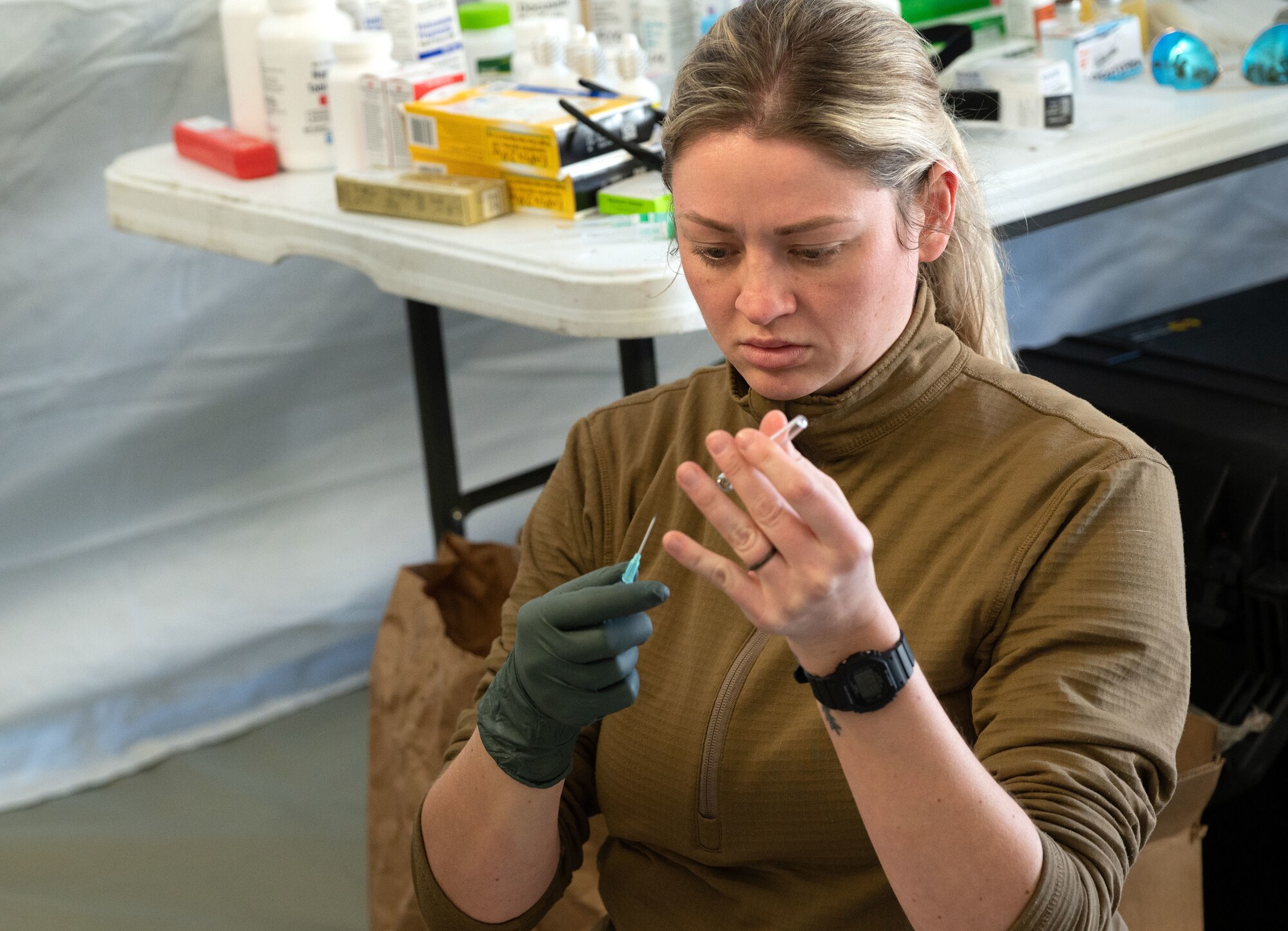 Tech. Sgt. Hailey Bass, 4th Operational Medical Readiness Squadron flight medicine technician, prepares a catheter for an IV drip for a simulated patient as part of a mass casualty event during exercise Agile Cub 4 at Marine Corps Air Station Cherry Point, North Carolina, March 8, 2023. The exercise scenario allowed medics assigned to the 4th Medical Group to receive advanced combat medical training in a deployed environment to ensure they are ready for any incident. This agile combat employment exercise shifts the generation of airpower from large, centralized bases to networks of smaller, dispersed locations