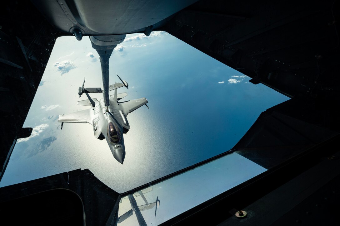 An aircraft is refueled in midair.