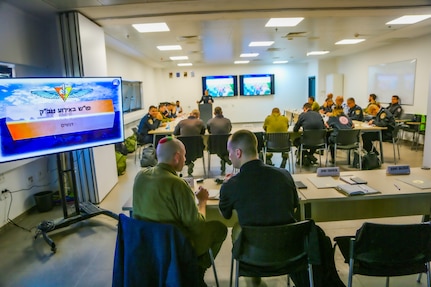 An Israeli translator explains the Commander's Course on Incident Command System to Sgt. 1st Class Nicholas Allee with the 7th CST, December 5, 2022