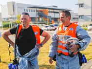 During a training event hosted by the Israel Home Front Command, two Israel soldiers take a breather after being in their PPE for the event.