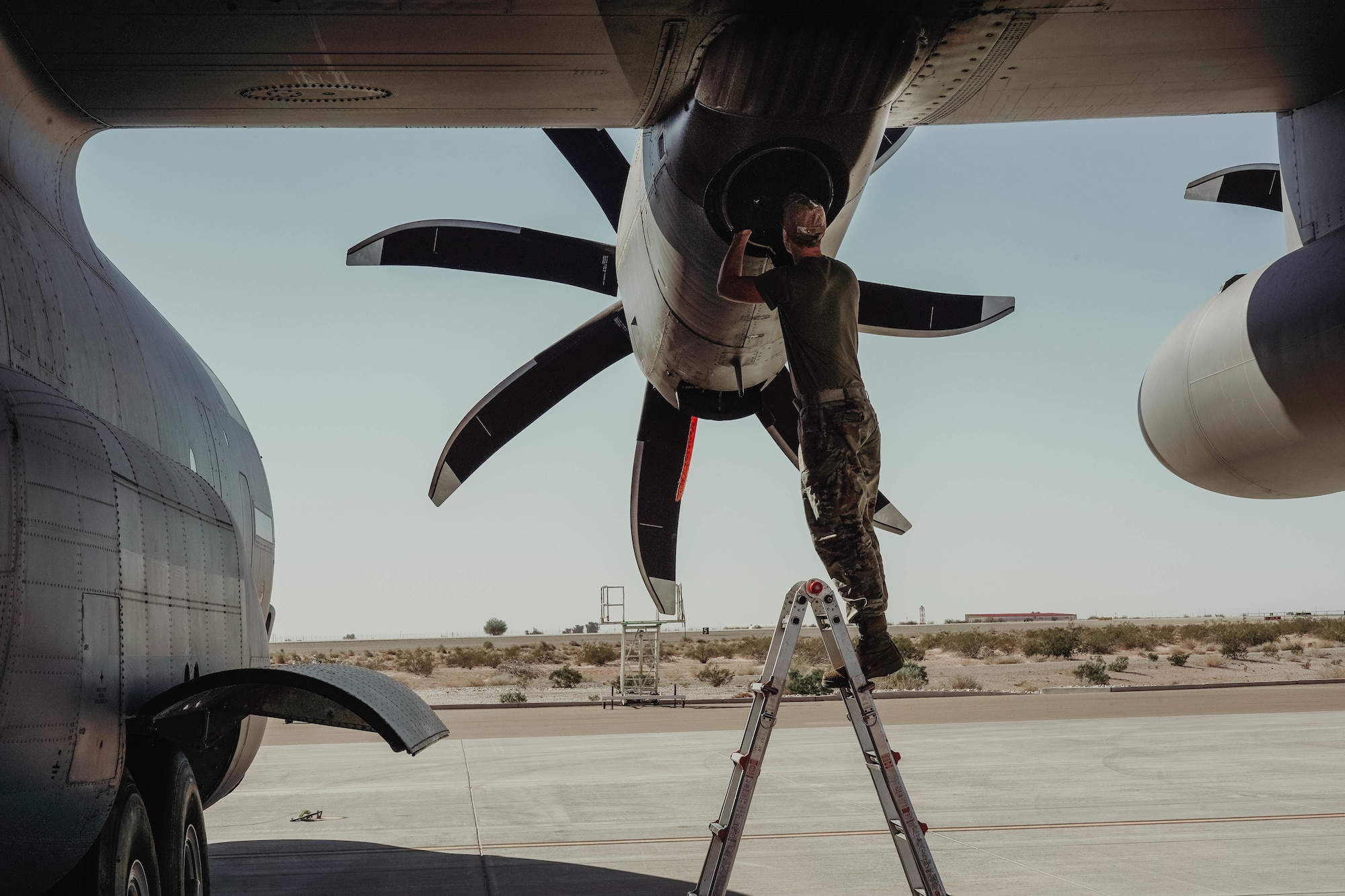U.S. Air Force Staff. Sgt. Jeffery Lyke, a crew chief with the 133rd Aircraft Maintenance Squadron, performs intake and exhaust inspections on the Rolls Royce T56-A-15 fitted to the C-130 Hercules in Yuma, Ariz., March 3, 2023.