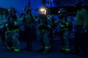 Sailors fight a simulated fire during a general quarters drill aboard USS Makin Island (LHD 8) in the South China Sea.