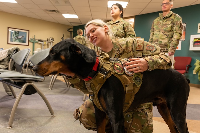 Staff Sgt. Sacia Vieregge, 934th Aeromedical Evacuation Squadron aeromedical evacuation technician, pets Tech. Sgt. Diesel, the 934 Aeromedical Staging Squadron therapeutic dog at the Minneapolis-St. Paul Air Reserve Station on March 5, 2023. Diesel was picked for his current role because he has a relaxed demeanor, enjoys being petted and likes meeting new people. (Senior Airman Colten Tessness)