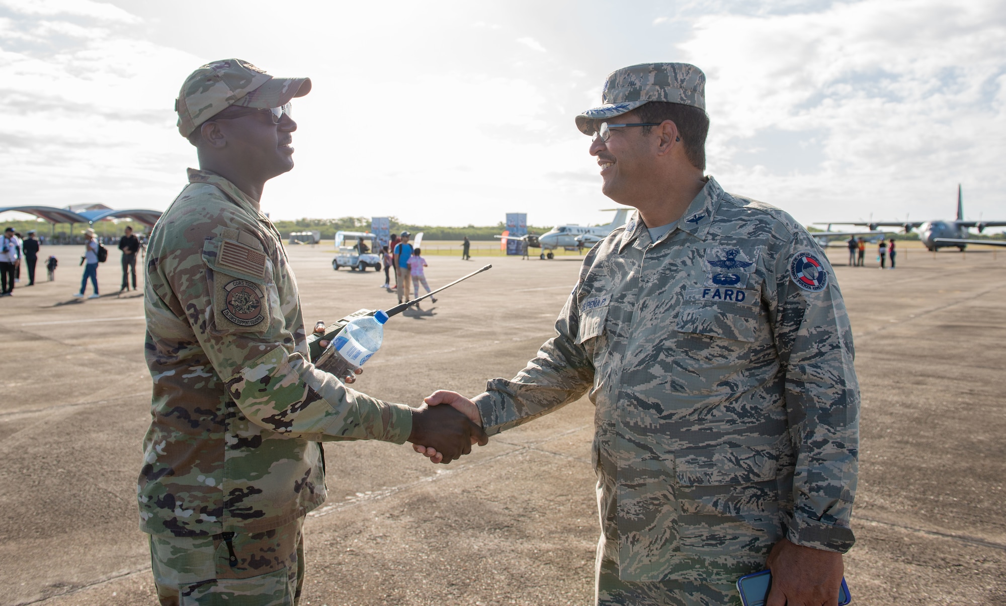 Col. Victor De Peña Paradas, San Isidro Base commander, shakes hands with Maj. Lawrence Thomas, 23rd Air Base Squadron deputy, during an airshow at San Isidro Air Base, Dominican Republic, Feb. 19, 2023.The airshow was dedicated to the FARD's 75th anniversary where both U.S. and Dominican Republic aircraft demonstrated capabilities and strengthened their bond as partner nations. (U.S. Air Force photo by Tech. Sgt. Jessica H. Smith-McMahan)