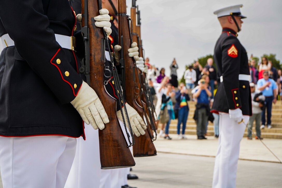 A firing party with Bravo Company, Marine Barracks Washington, executes present arms during an Honor Flight Network performance at the Lincoln Memorial, Washington, D.C. April 25, 2022.  The Honor Flight Network transports veterans to Washington, D.C. to visit memorials in honor of their service to the country. (U.S. Marine Corps photo by Lance Cpl. Pranav Ramakrishna)