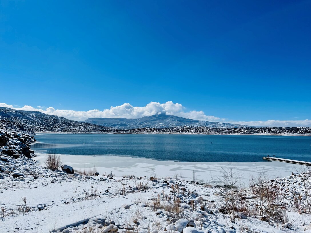 ABIQUIU LAKE, N.M. – Ice forms around the lake’s shoreline and snow dusts Cerro Pedernal in this photo taken Feb. 3, 2022, by Pamela Bowie.