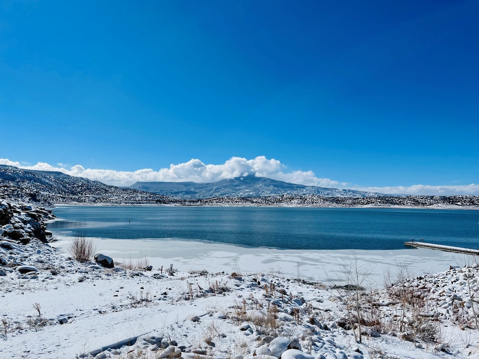 ABIQUIU LAKE, N.M. – Ice forms around the lake’s shoreline and snow dusts Cerro Pedernal in this photo taken Feb. 3, 2022, by Pamela Bowie.