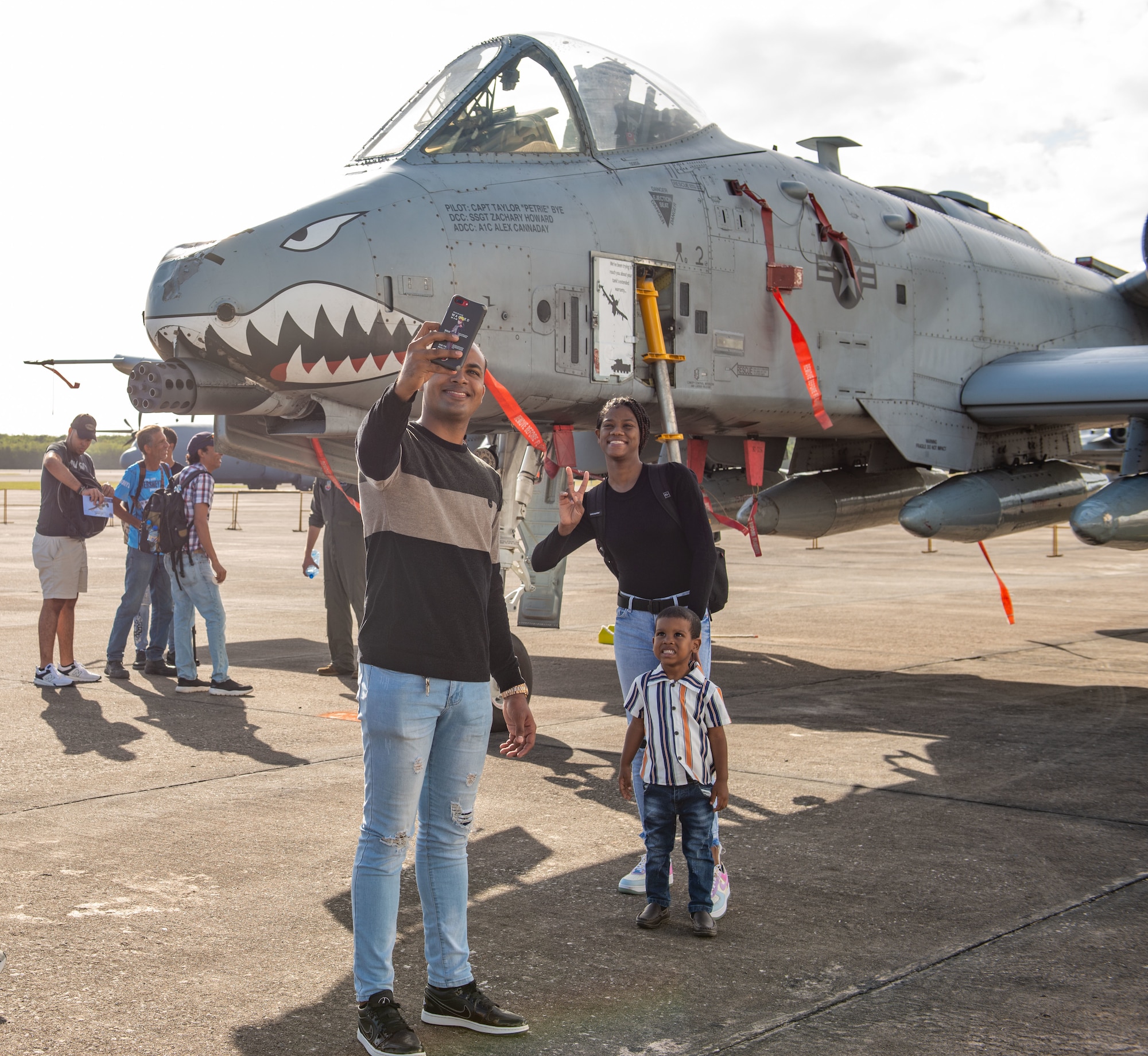 A family takes a photo in front of an A-10C Thunderbolt II during an airshow at San Isidro Air Base, Dominican Republic, Feb. 19, 2023.The airshow was dedicated to the Dominican Republic’s 75th anniversary where both U.S. and Dominican Republic aircraft demonstrated capabilities and strengthened their bond as partner nations.(U.S. Air Force photo by Tech. Sgt. Jessica H. Smith-McMahan)