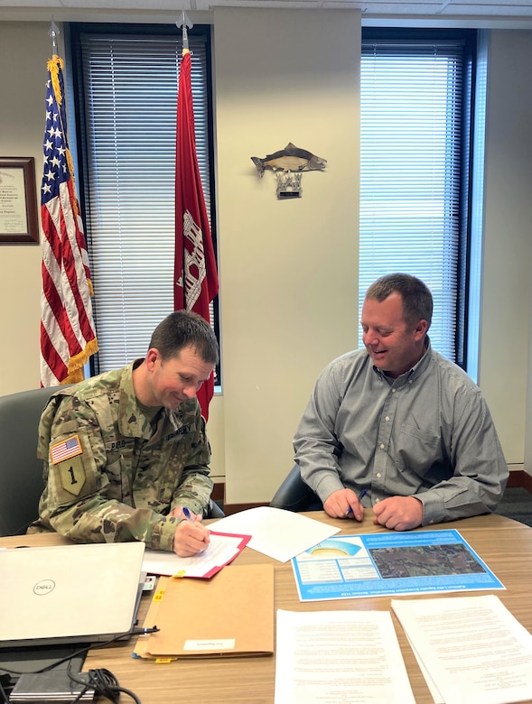 Col. Travis Rayfield, commander and district engineer for the Kansas City District, U.S. Army Corps of Engineers with Todd Gemeinhardt, chief of the Planning Branch, engage over Webex with personnel from the Iowa Department of Natural Resources as Rayfield signs a Project Partnership Agreement with them for a Section 1135 aquatic restoration project for Rathbun Lake, Iowa.