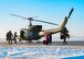 Senior Airman Garrett Hightower (left), 54th Helicopter Squadron (HS) flight engineer, lowers Airman 1st Class Caulder Taylor (bottom center), 54th HS special missions aviator, to the ground with a rescue hoist from a UH-1N Huey in rural North Dakota, March 13, 2023. 54th HS helicopters typically fly from ground level to 2,000 feet above ground level. Operations may require flight up to 15,000 feet above mean sea level. (U.S. Air Force photo by Staff Sgt. Michael A. Richmond)