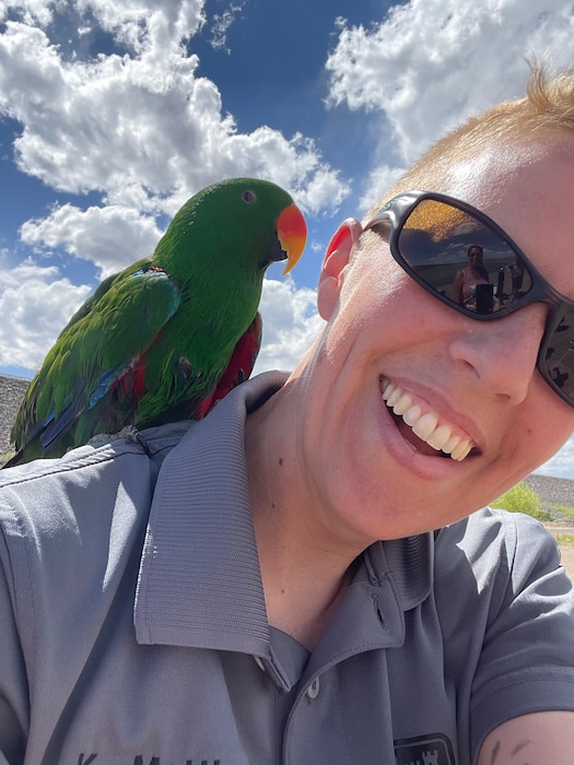 COCHITI LAKE, N.M. – While the signs clearly state, “No pets on beach,” some visitors still think that it only applies to dogs. Here park ranger Karyn Matthews poses with a pet bird on the beach, May 29, 2022. Photo by Karyn Matthews.