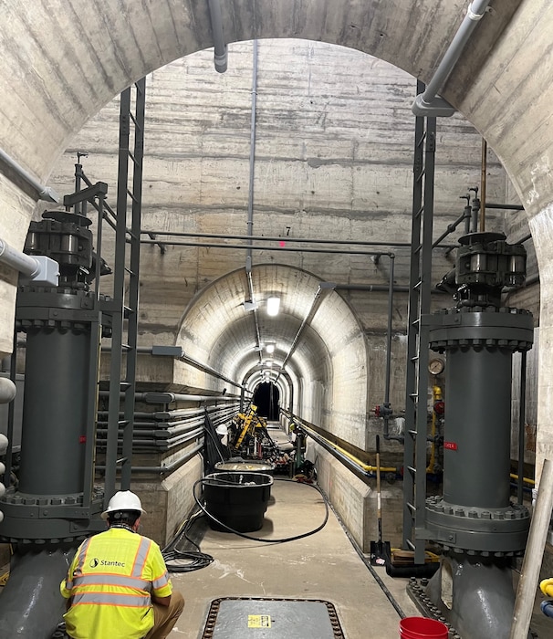 JOHN MARTIN DAM, Colo. – A contractor’s drilling team and rig operate inside the operating gallery of the dam, July 10, 2022. The drill rig is near the emergency and service gate sluices. Photo by Chris Carroll.