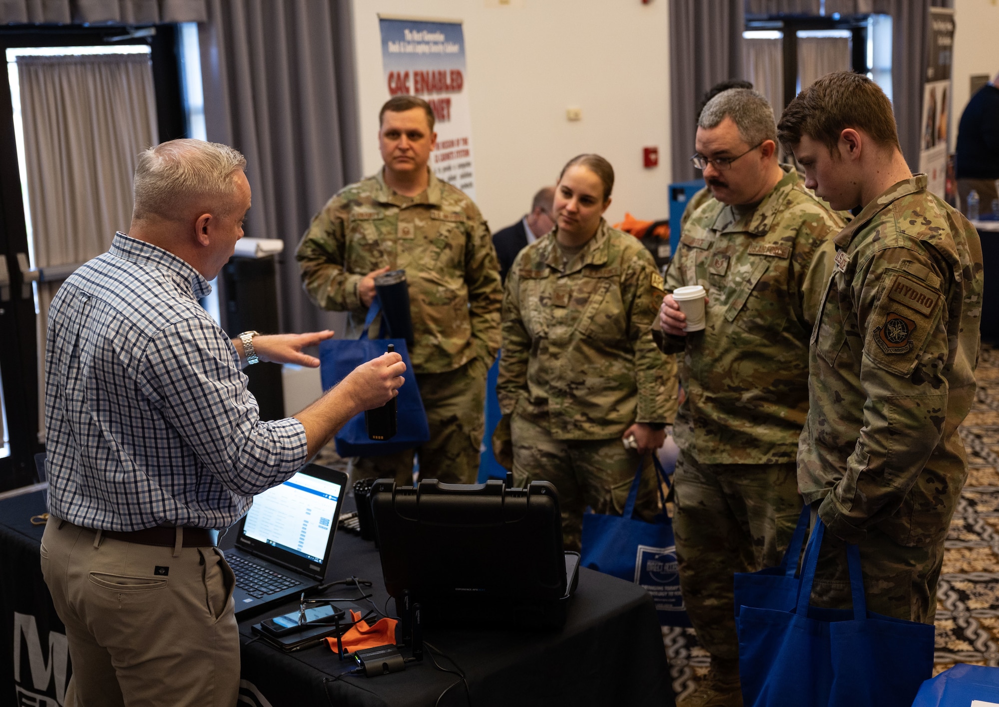 Team Dover Airmen speak with Scout Outten, a Magnum Electronics Inc. representative, during the 2023 Dover Air Force Base Tech Expo at Dover AFB, Delaware, March 15, 2023. The event provided Airmen the opportunity to meet face to face with leading tech companies. (U.S. Air Force photo by Senior Airman Cydney Lee)