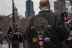 A man stands at the starting point of the St. Patrick’s Day Parade in Chicago, Illinois, Mar. 11, 2023. Soldiers of the 1st Infantry Division visited Chicago as part of an ongoing effort to highlight noncommissioned officers and support recruitment efforts in the region. (U.S. Army photo by Spc. Charles Leitner)
