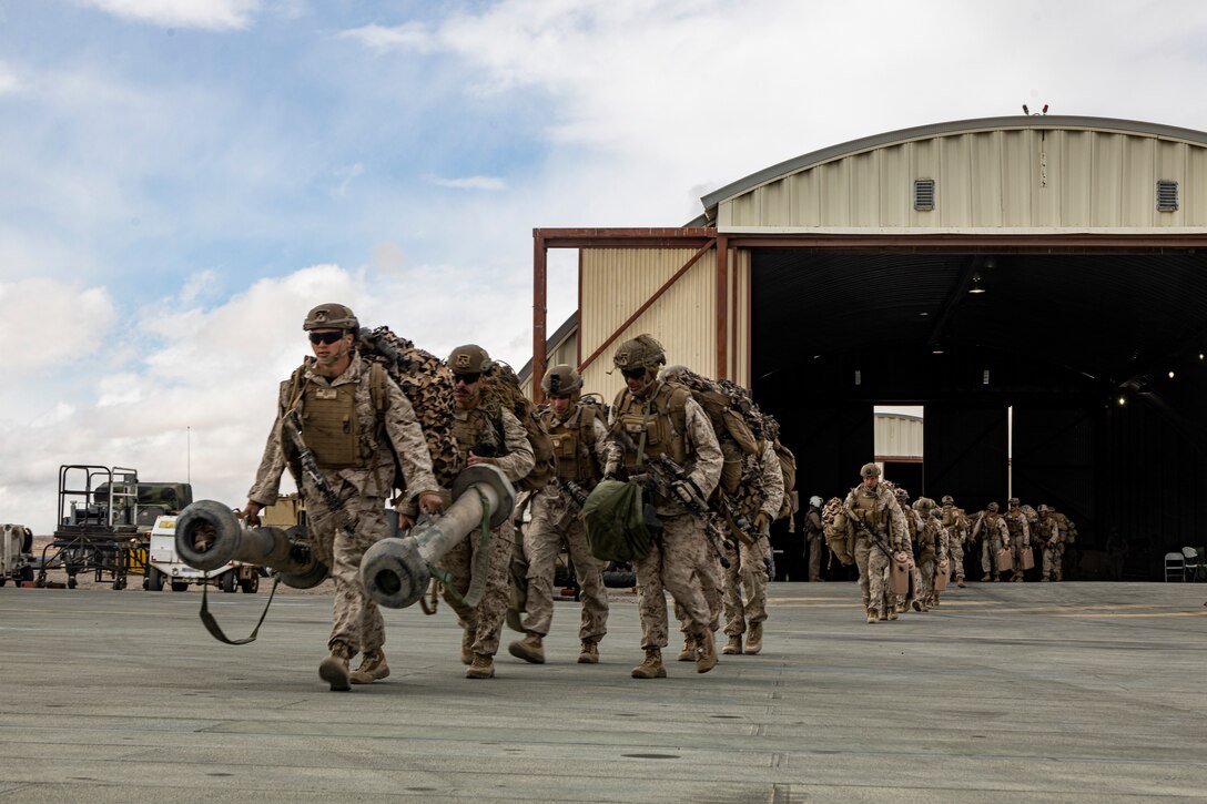 U.S. Marines with Fox Company, 2nd Battalion, 7th Marine Regiment (REIN), prepare to board a CH-53E Super Stallion during Marine Air-Ground Task Force Warfighting Exercise (MWX) 2-23 at Marine Corps Air Ground Combat Center, Twentynine Palms, California, Feb. 23, 2023. MWX is the culminating event of Service Level Training Exercise 2-23, that improves U.S. and allied service members’ operational capabilities. (U.S. Marine Corps Sgt. Armando Elizalde)