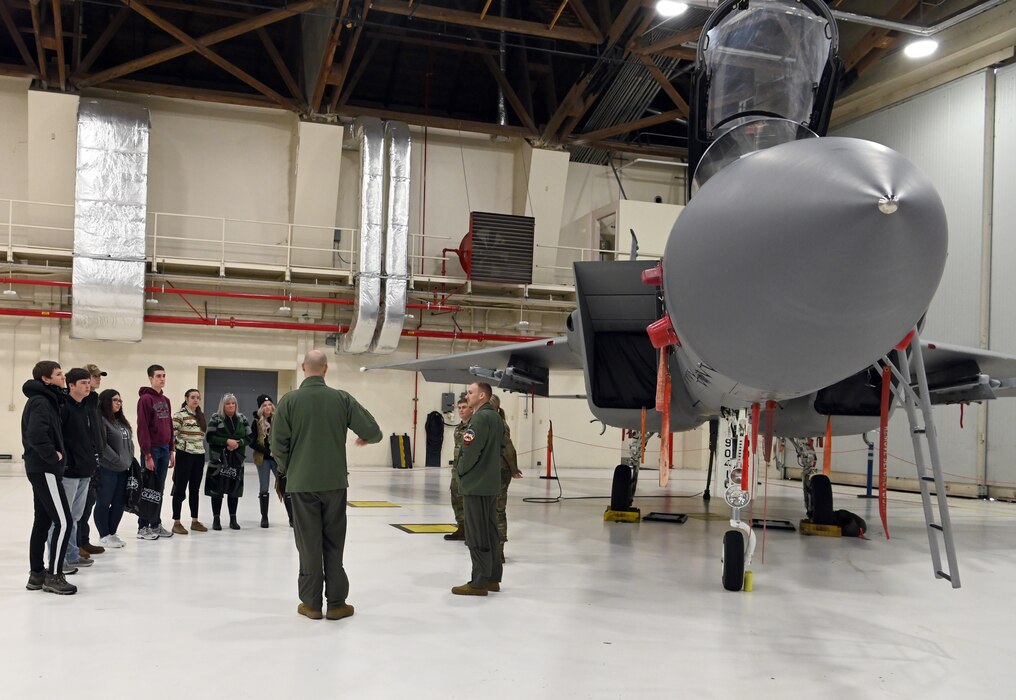 high school students look at military equipment