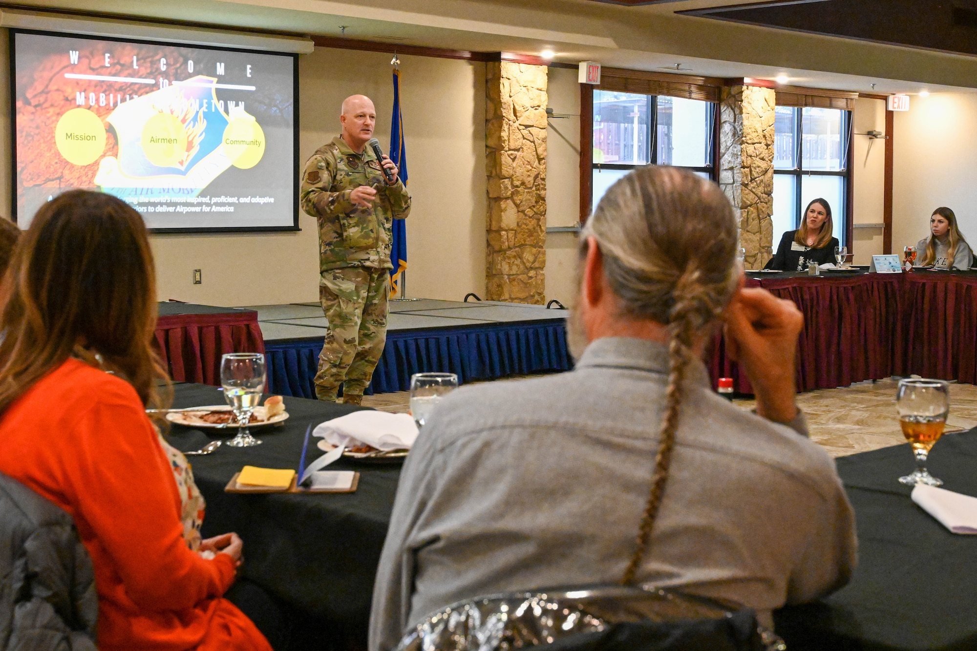 U.S. Air Force Col. Blaine Baker, 97th Air Mobility Wing commander, speaks to members of Leadership Oklahoma during a luncheon at Altus Air Force Base, Oklahoma, March 14, 2023. During the event, Baker gave the wing’s mission brief and escorted the members on their tour of a C-17 Globemaster III. (U.S. Air Force photo by Senior Airman Trenton Jancze)