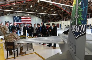 high school students look at military equipment