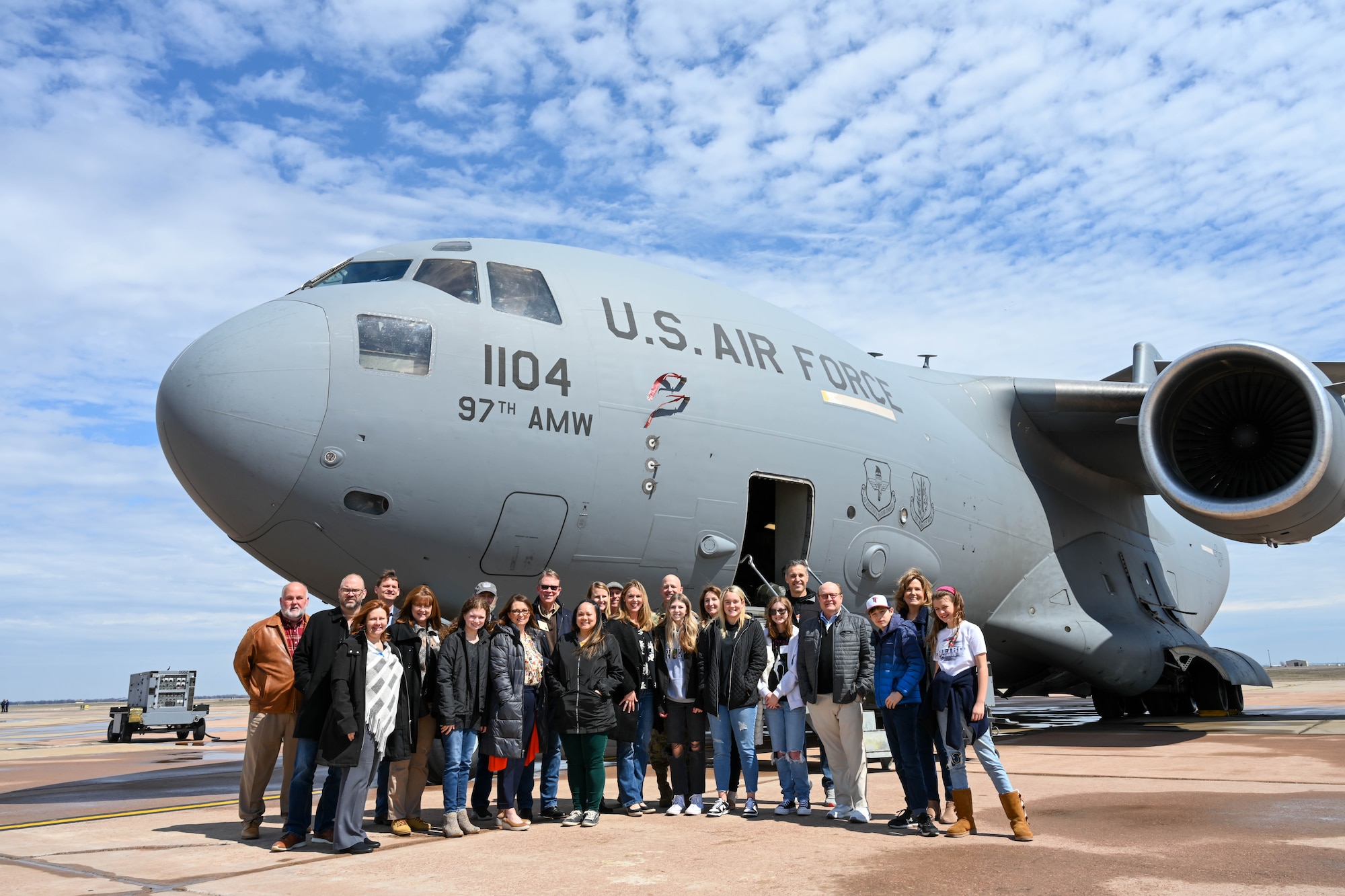 U.S. Air Force Col. Blaine Baker, 97th Air Mobility Wing commander, poses for a photo with members of Leadership Oklahoma on the flightline at Altus Air Force Base (AFB), Oklahoma, March 14, 2023. The visit was an opportunity for community members to understand what Airmen at Altus AFB do to generate mobility airpower for the Air Force. (U.S. Air Force photo by Senior Airman Trenton Jancze)