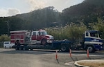 A firetruck is pulled on a semi-truck.