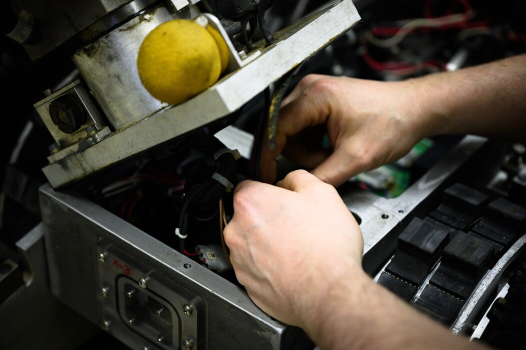 Airmen works on robot