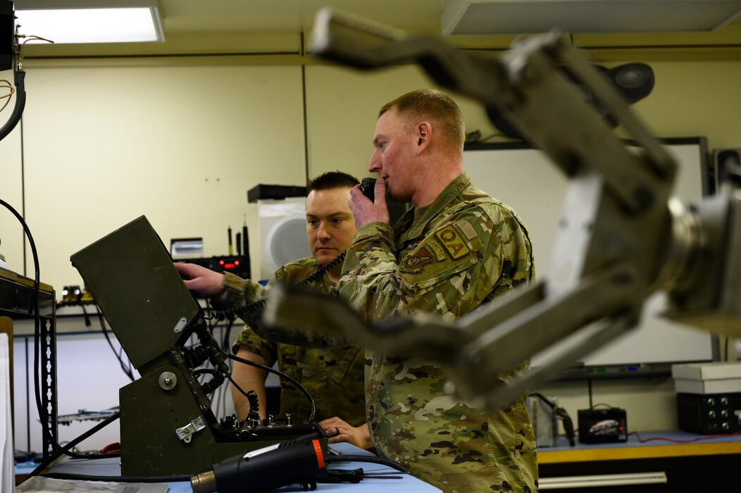 Airmen works on robot