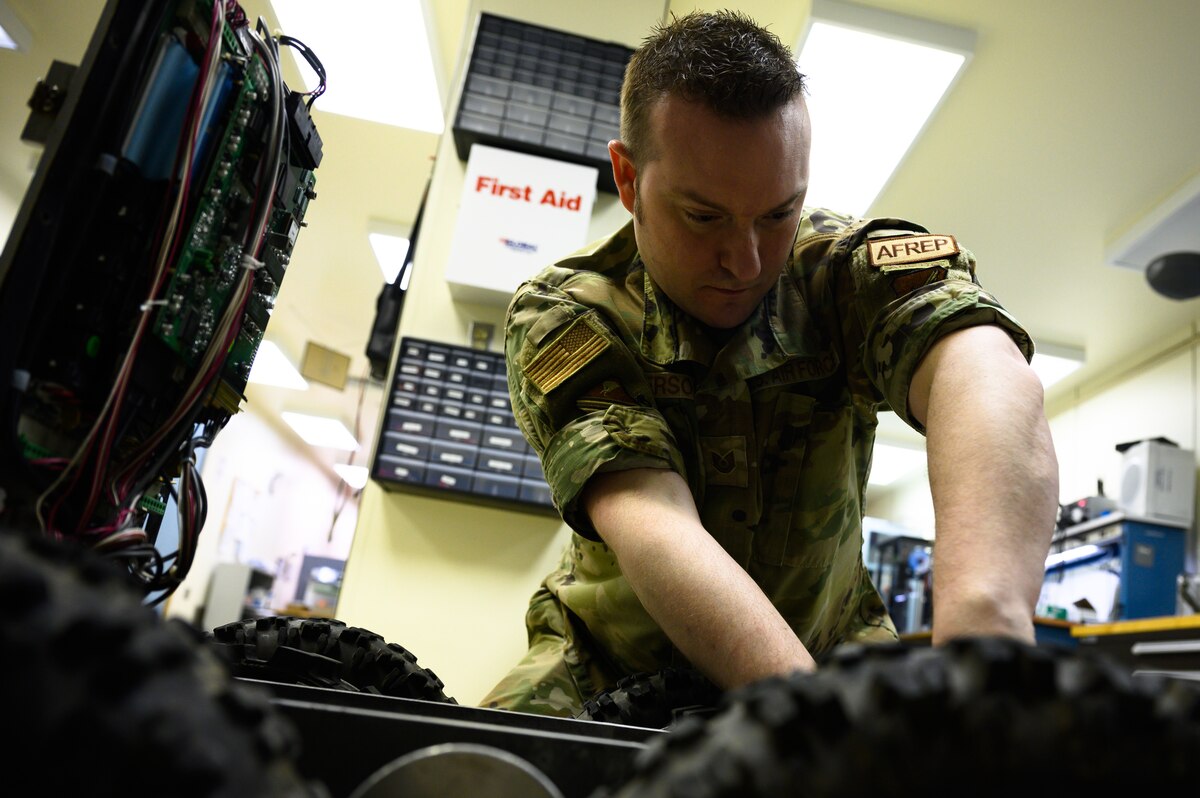 Airmen works on robot