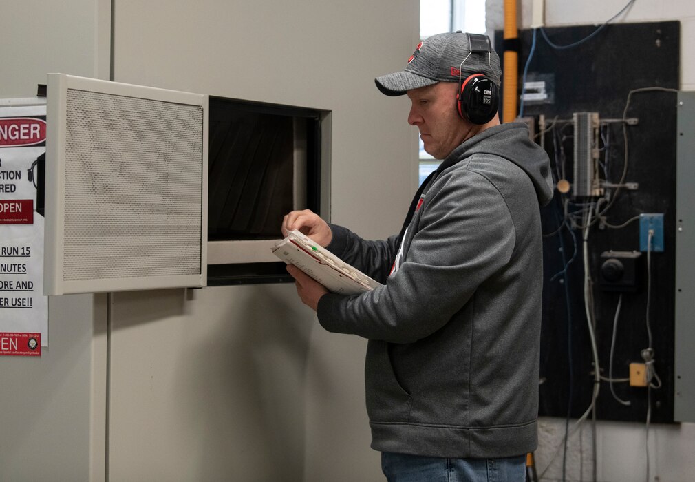 Ken Adams, security specialist for the 88th Air Base Wing’s Information Protection Directorate, discards material March 10, 2023, during the annual Classified Cleanout Day at Wright-Patterson Air Force Base, Ohio. The Department of Defense requires all activities to properly destroy unneeded classified material at least one day per year.