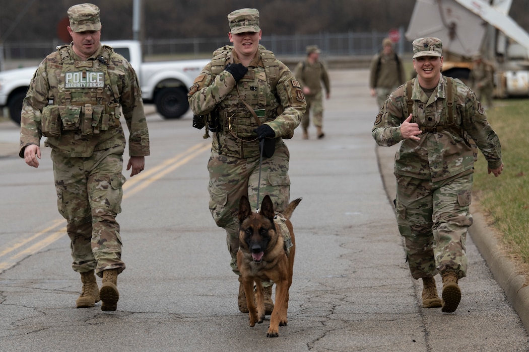 From left: Tech. Sgt. Eric Hoffman, 88th Security Forces Squadron investigator; Staff Sgt. Lacey Bockman, 88 SFS military working dog handler; and Lt. Col. Nicole Schatz, 88 SFS commander, join MWD Kkaun during the K-9 Veterans Day Ruck on March 10, 2023, at Wright-Patterson Air Force Base, Ohio. This year’s road march helped raise donations for a nonprofit organization to go toward those affected by the train derailment in East Palestine, Ohio.