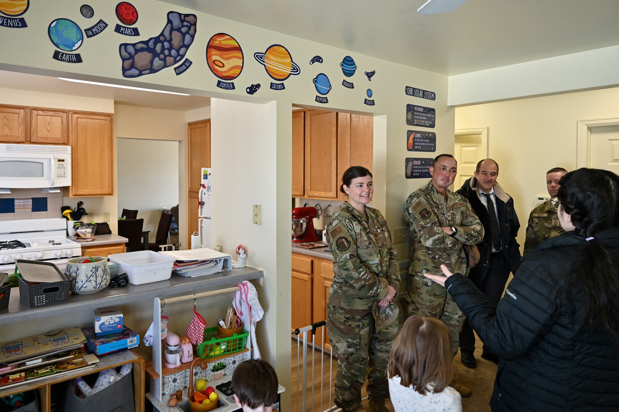Aimmee Lee, new family child care provider, shows her activity room to Maj. Jennifer Holmstrom, 90th Force Support Squadron commander, Col. John Dines, 90th Mission Support Group commander, and Thomas Cox, 90 FSS deputy director, on F. E. Warren Air Force Base, Wyoming, Feb. 28, 2023. FCC providers give parents peace of mind about their child’s well-being so they can fully focus on the mission. (U.S. Air Force photo by Joseph Coslett Jr.)