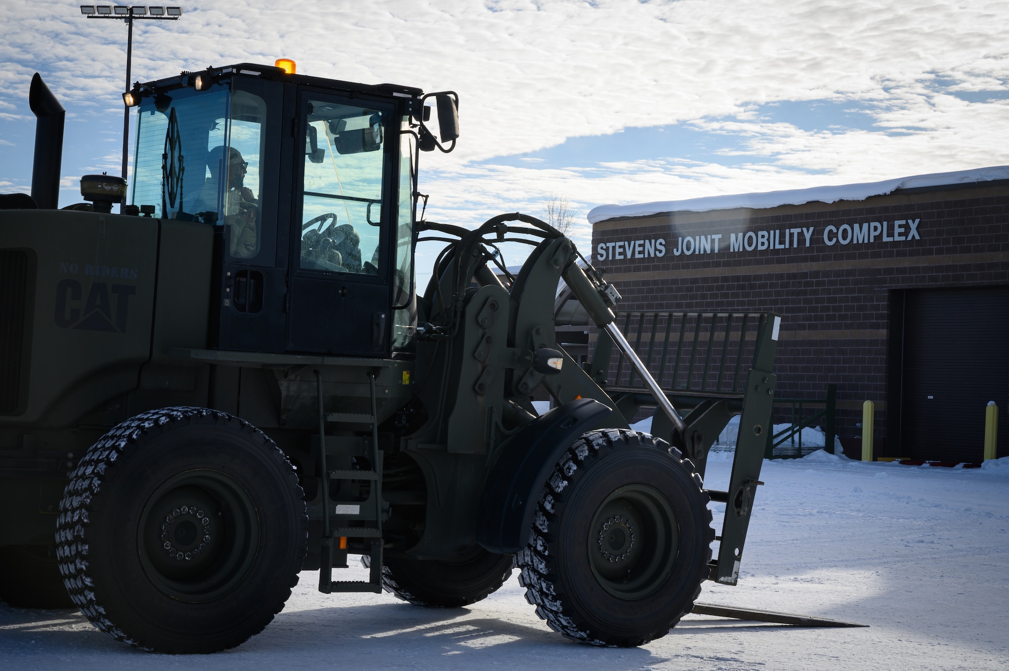 U.S. Air Force Airman 1st Class Tyler Drayton, 354th Logistics Readiness Squadron ground transportation operator journeyman, sits parked in a forklift outside the Stevens Joint Mobility Complex at Eielson Air Force Base, Alaska, during exercise Arctic Gold 23-1, March 7, 2023.