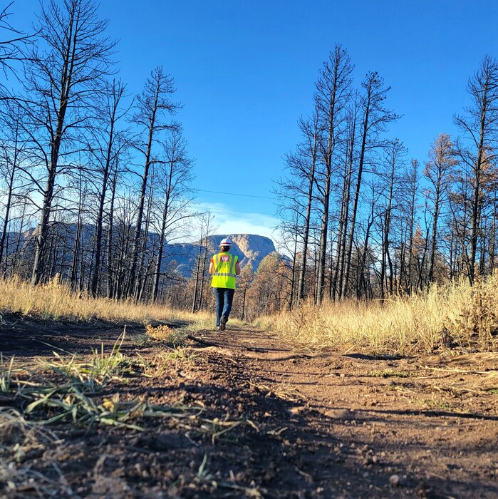 SAN MIGUEL COUNTY, N.M. – A USACE responder hikes a trail between two work sites near Hermits Peak, Nov. 23, 2022. The Albuquerque District managed the 2022 New Mexico Wildfire Debris Mission in the aftermath of the Hermits Peak/Calf Canyon Fire, the largest wildfire in state history. Photo by Holly Garnett.