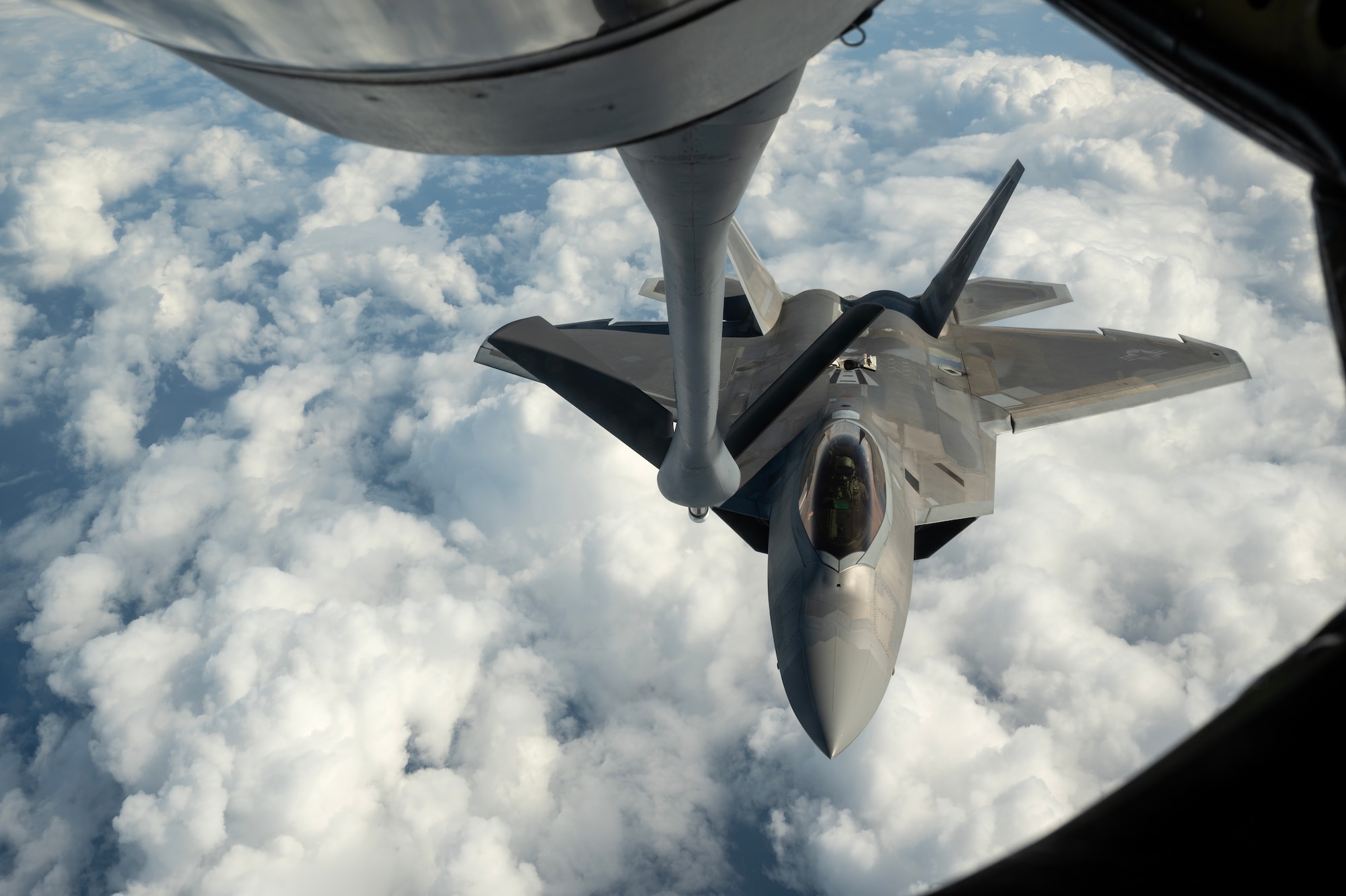 An F-22A Raptor assigned to the 525th Fighter Squadron flies approaches a KC-135 Stratotanker to receive aerial refueling over the South China Sea, March 13, 2023 in support of a subject matter expert exchange and bilateral training mission with the Philippine Air Force. By strengthening partnerships through bilateral engagements with key Allies like the Philippines, PACAF enhances a networked security architecture capable of deterring common threats, protecting shared resources and upholding sovereignty throughout the Indo-Pacific region. (U.S. Air Force photo by Senior Airman Jessi Roth)