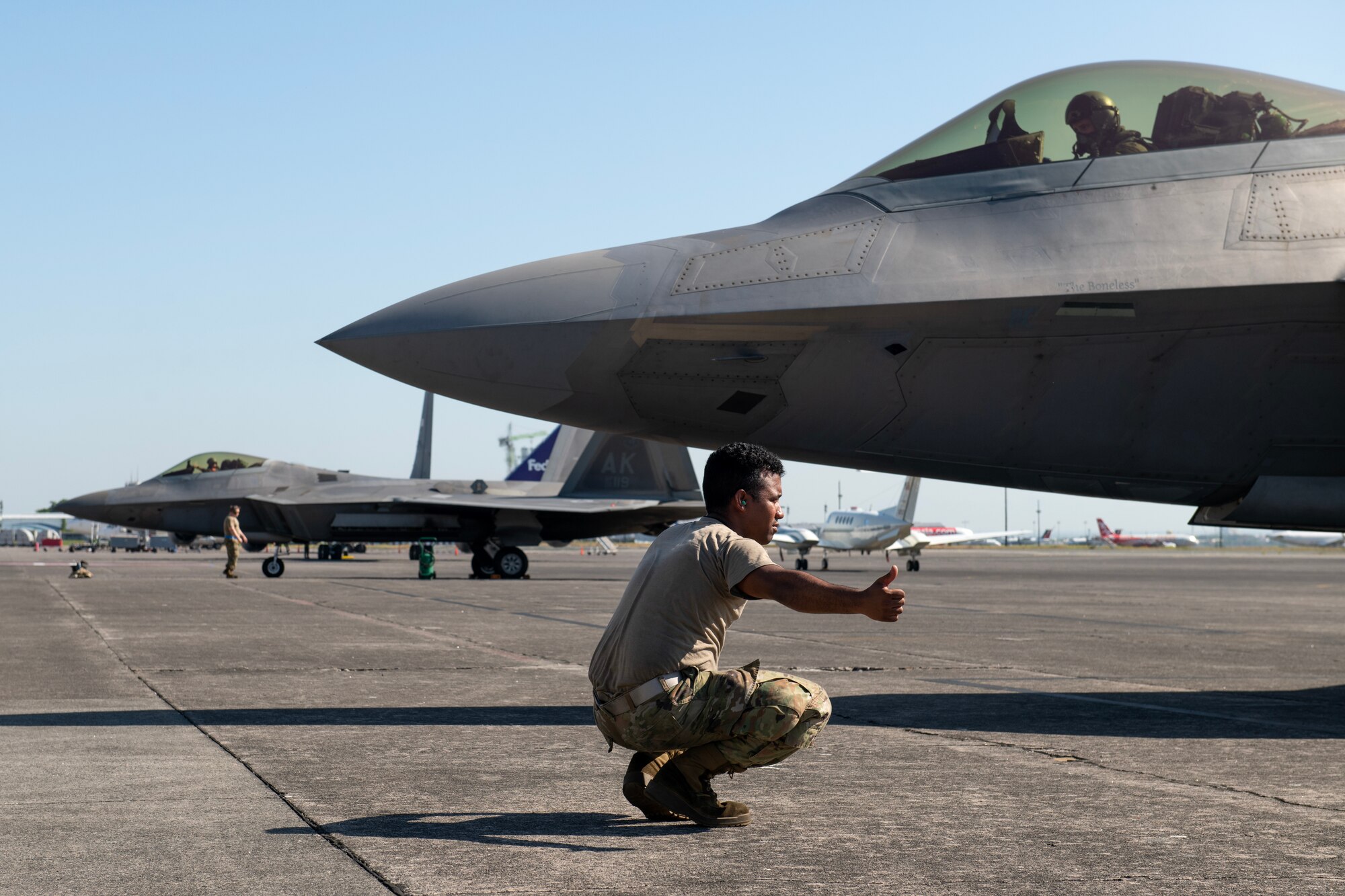 U.S. Air Force Senior Airman Randy Siri, 3rd Aircraft Maintenance Squadron crew chief, conducts pre-flight checks of an F-22A Raptor prior to a bilateral training flight out of Clark Air Base, Philippines, March 14, 2023. By strengthening partnerships through bilateral engagements with key Allies like the Philippines, PACAF enhances a networked security architecture capable of deterring common threats, protecting shared resources and upholding sovereignty throughout the Indo-Pacific region. (U.S. Air Force photo by Senior Airman Jessi Roth)