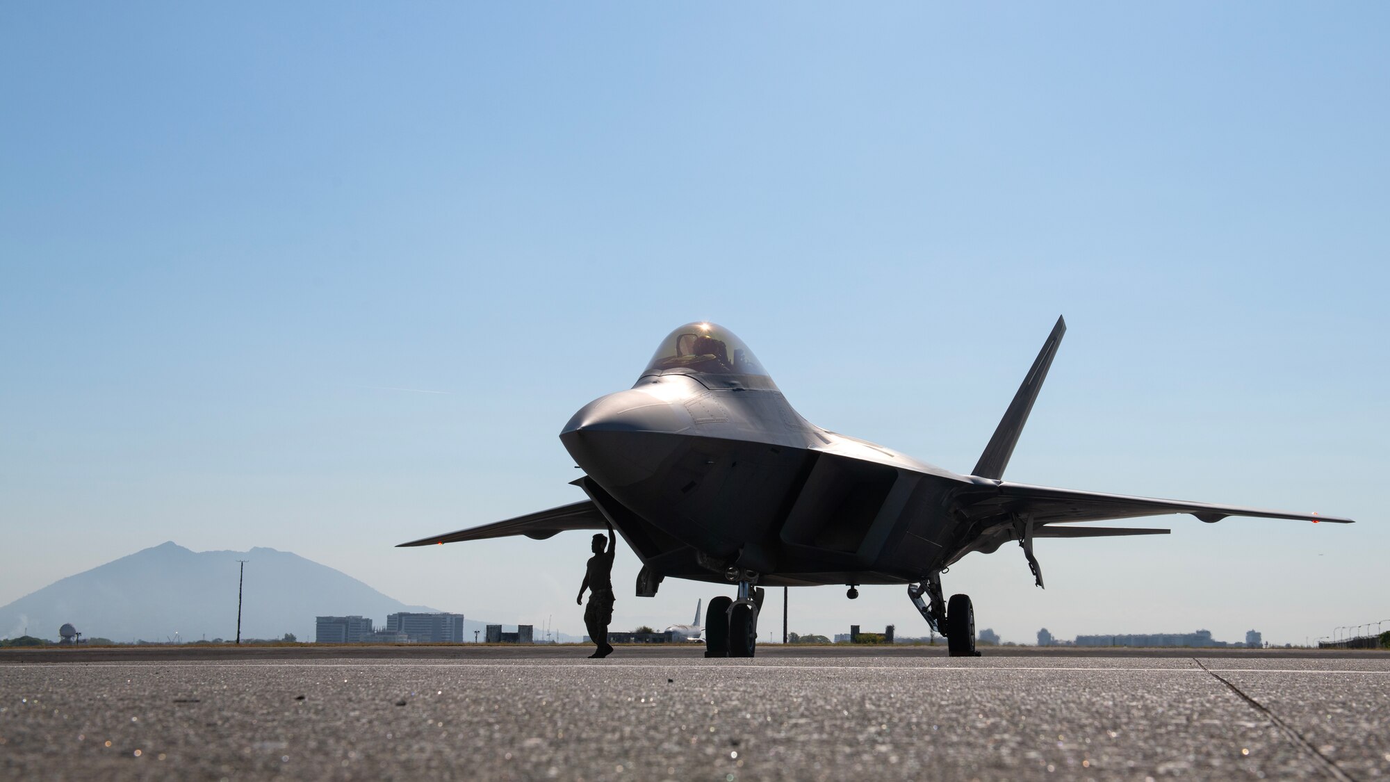 U.S. Air Force Senior Airman Randy Siri, 3rd Aircraft Maintenance Squadron crew chief, conducts pre-flight checks on an F-22A Raptor prior to a bilateral training flight out of Clark Air Base, Philippines, March 14, 2023. By strengthening partnerships through bilateral engagements with key Allies like the Philippines, PACAF enhances a networked security architecture capable of deterring common threats, protecting shared resources and upholding sovereignty throughout the Indo-Pacific region. (U.S. Air Force photo by Senior Airman Jessi Roth)