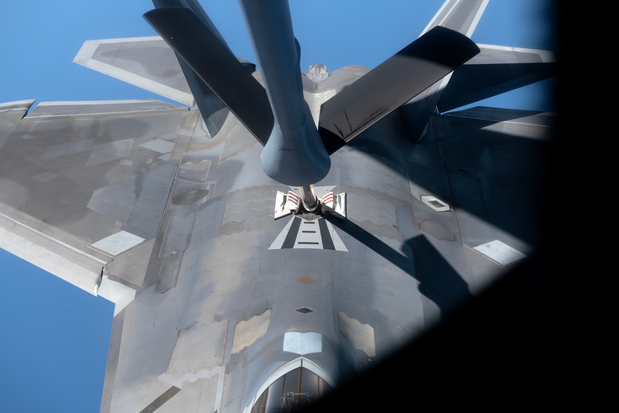 An F-22A Raptor assigned to the 525th Fighter Squadron makes contact with a KC-135 Stratotanker over the South China Sea, March 14, 2023, in support of a bilateral training mission with the Philippine Air Force. Enhancing interoperability between the U.S. and Philippine air forces contributes to the long-term advancement of our nations’ shared interest in maintaining a free and open Indo-Pacific. (U.S. Air Force photo by Senior Airman Jessi Roth)