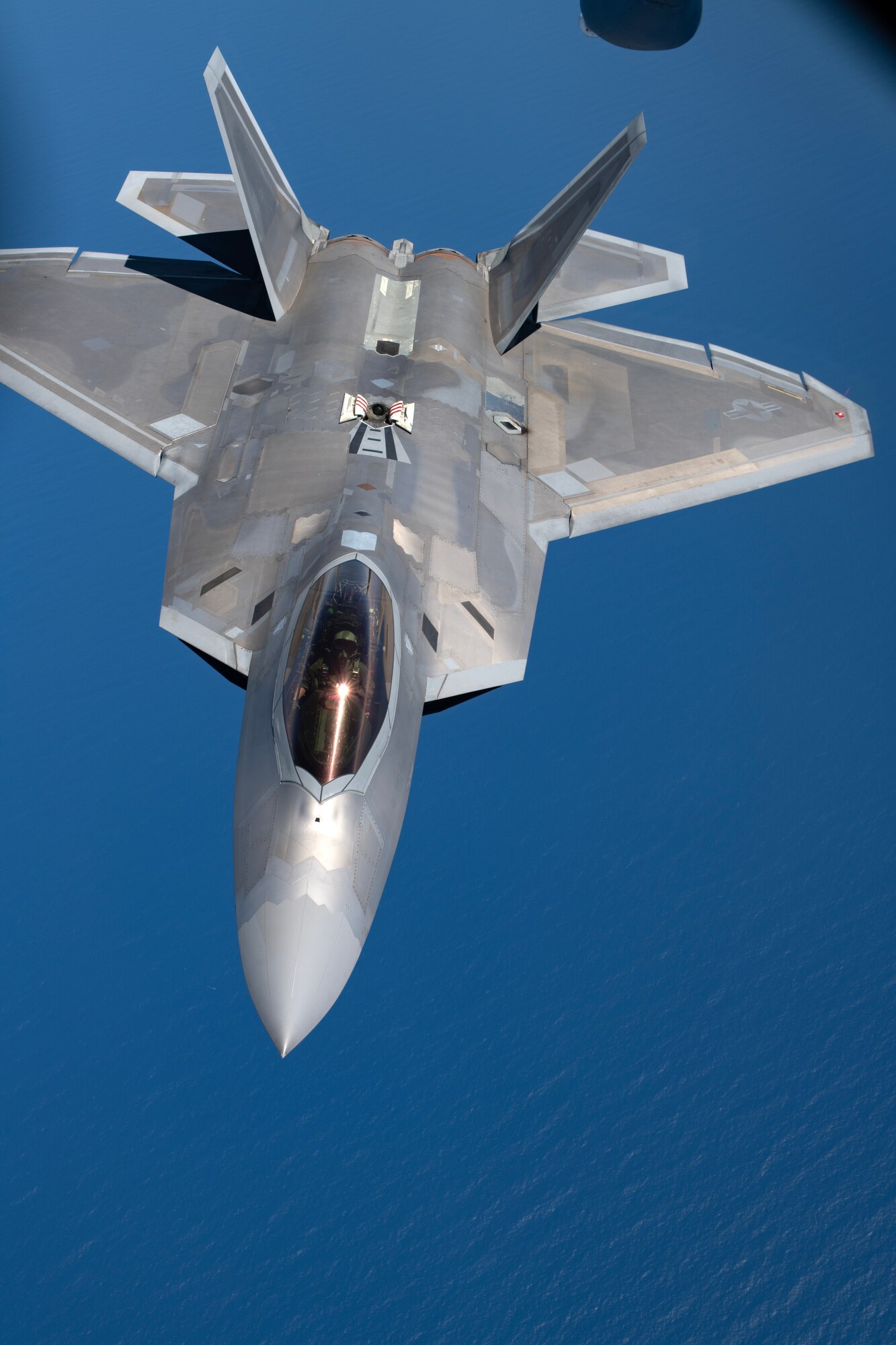 An F-22A Raptor assigned to the 525th Fighter Squadron departs after aerial refueling over the South China Sea, March 14, 2023 in support of a bilateral training mission with the Philippine Air Force. Bilateral training and cooperation with our Philippine Air Force counterparts enhances the mutual readiness required to defend security, prosperity, and peace throughout the Indo-Pacific region. (U.S. Air Force photo by Senior Airman Jessi Roth)