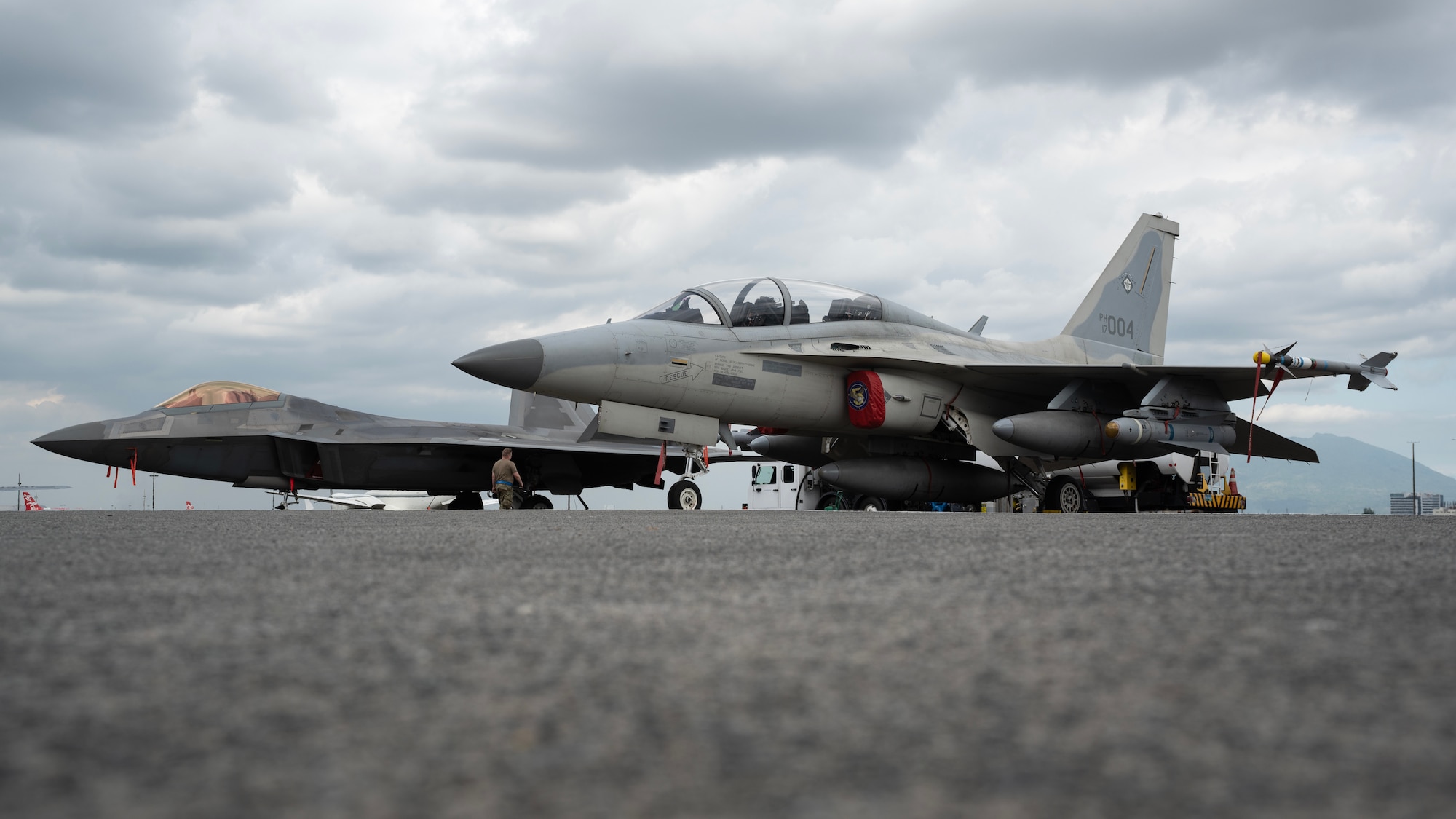 A U.S. Air Force F-22A Raptor and a Philippine Air Force FA-50PH are parked on the flightline during a static aircraft display at Clark Air Base, Philippines, March 13, 2023. Integrating and training alongside the Philippine Air Force promotes interoperability, builds upon our strong alliance, and reaffirms the commitment to the Mutual Defense Treaty and maintaining peace and stability throughout the Indo-Pacific region. (U.S. Air Force photo by Senior Airman Jessi Roth)