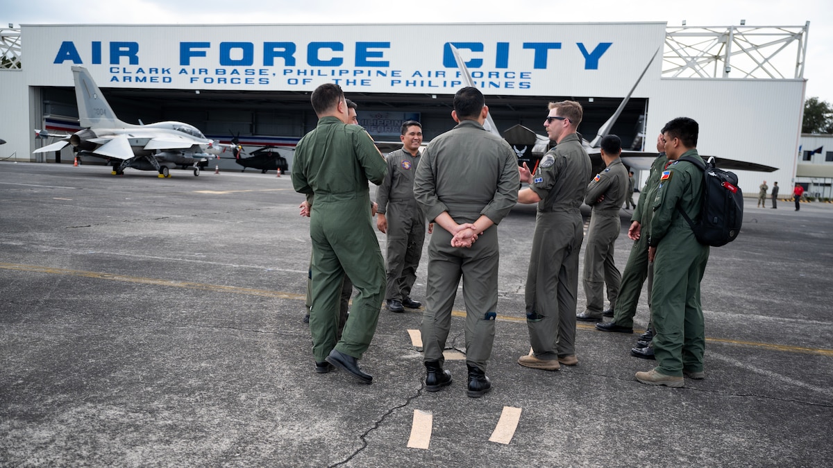 U.S. Air Force Capt. Joe Baumann, 525th Fighter Squadron F-22A Raptor pilot, discusses aircraft capabilities with pilots from the Philippine Air Force during a static aircraft tour at Clark Air Base, Philippines, March 13, 2023. Bilateral training and cooperation with our Philippine Air Force counterparts enhances the mutual readiness required to defend security, prosperity, and peace throughout the Indo-Pacific region. (U.S. Air Force photo by Senior Airman Jessi Roth)